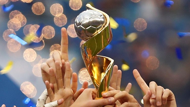 FILE - In this July 7, 2019, file photo, the United States players hold the trophy as they celebrate winning the Women&#39;s World Cup final soccer match against The Netherlands at the Stade de Lyon in Decines, outside Lyon, France. FIFA has received bids from Brazil, Japan, Colombia and a joint bid from Australia and New Zealand to host the 2023 Women&#39;s World Cup on Friday, Dec. 13, 2019. (AP Photo/Francisco Seco, File)