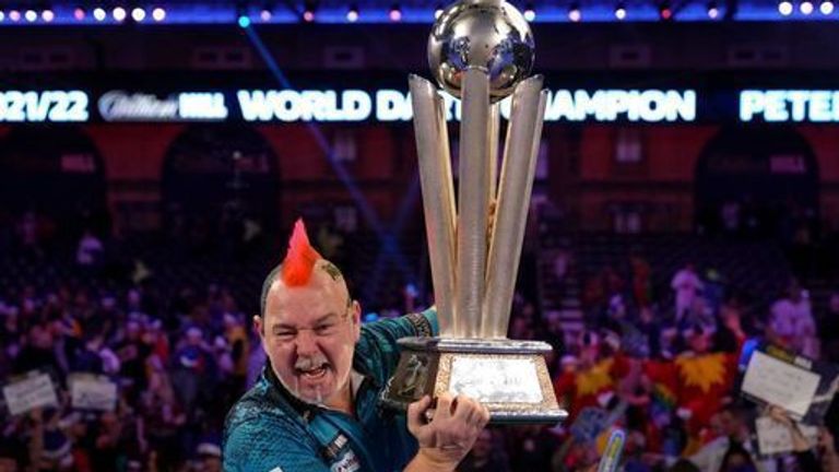 Peter Wright celebrates with the Sid Waddell Trophy after victory against Michael Smith during day sixteen of the William Hill World Darts Championship at Alexandra Palace, London. Picture date: Monday January 3, 2022.
