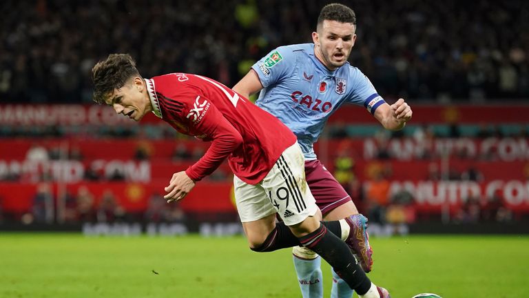 Aston Villa's John McGinn, right, challenges for the ball with Manchester United's Alejandro Garnacho during the English League Cup third round soccer match between Manchester United and Aston Villa in Manchester, England, Thursday, Nov. 10, 2022. (AP Photo/Dave Thompson)