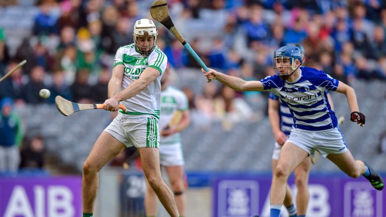 27 November 2022; Joey Cuddihy of Shamrocks Ballyhale scores his side's second goal as Harry Carroll of Naas closes in during the AIB Leinster GAA Hurling Senior Club Championship Semi-Final match between Naas and Shamrocks Ballyhale at Croke Park in Dublin. Photo by Stephen Marken/Sportsfile