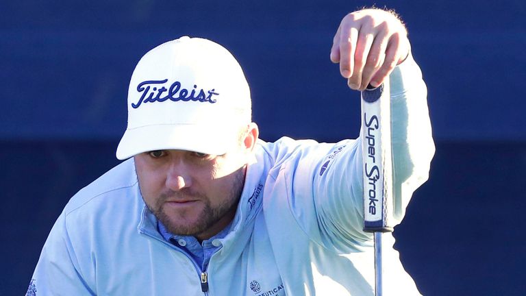Ben Taylor checks the lie before putting on the 17th green during the third round of the Houston Open golf tournament, Saturday, Nov. 12, 2022, in Houston. (AP Photo/Michael Wyke)