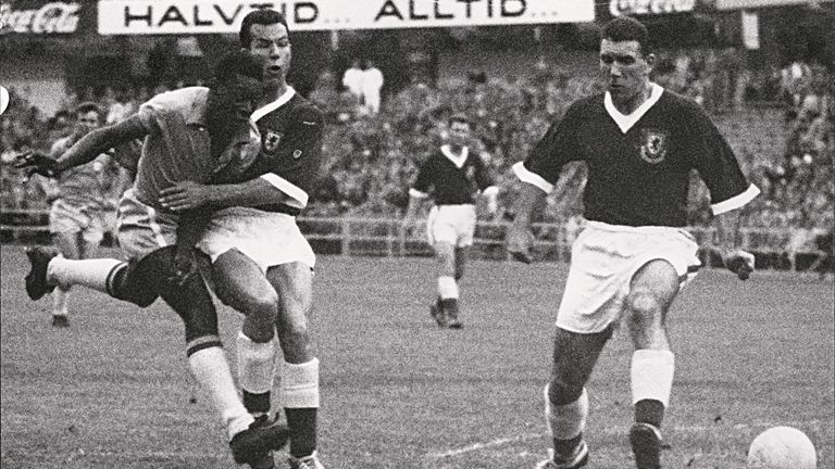 17-year-old Brazilian forward Pele (L) kicks the ball past two Welsh defenders during the World Cup quarter final between Brazil and Wales in 1958