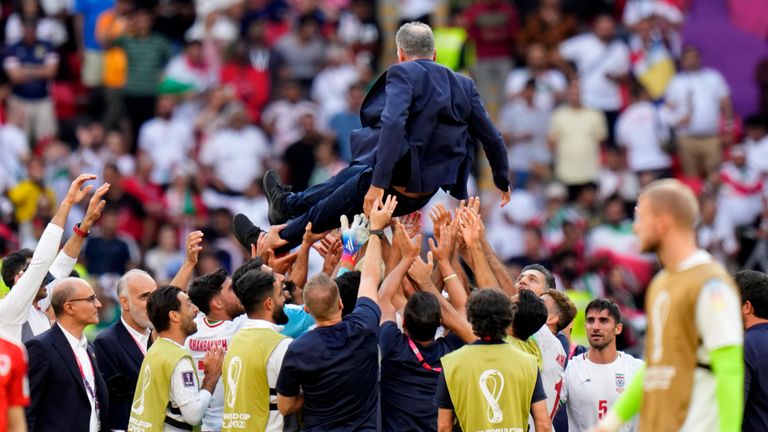 Carlos Queiroz is thrown up in air by his players following the 2-0 win over Wales