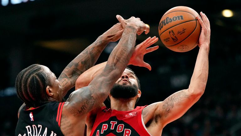 Chicago Bulls forward DeMar DeRozan (11) looks to block Toronto Raptors guard Fred VanVleet (23) who goes for a layup during second-half NBA basketball game action in Toronto, Sunday, Nov. 6, 2022. (Frank Gunn/The Canadian Press via AP)