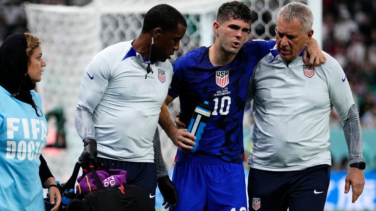 Christian Pulisic of the USA is helped off the pitch after suffering an injury