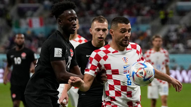 Croatia&#39;s Mateo Kovacic, right, fights for the ball with Canada&#39;s Ismael Kone, left, and Canada&#39;s Alistair Johnston during the World Cup group F soccer match between Croatia and Canada, at the Khalifa International Stadium in Doha, Qatar, Sunday, Nov. 27, 2022. (AP Photo/Thanassis Stavrakis)