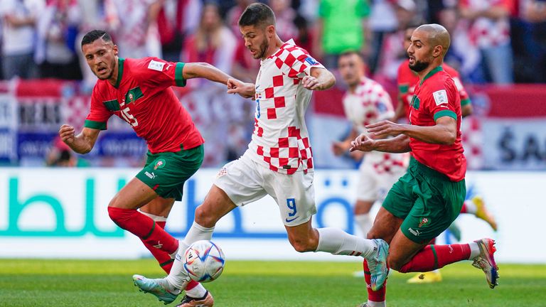 Croatia&#39;s Andrej Kramaric competes for the ball with Morocco&#39;s Selim Amallah (left) and Sofyan Amrabat