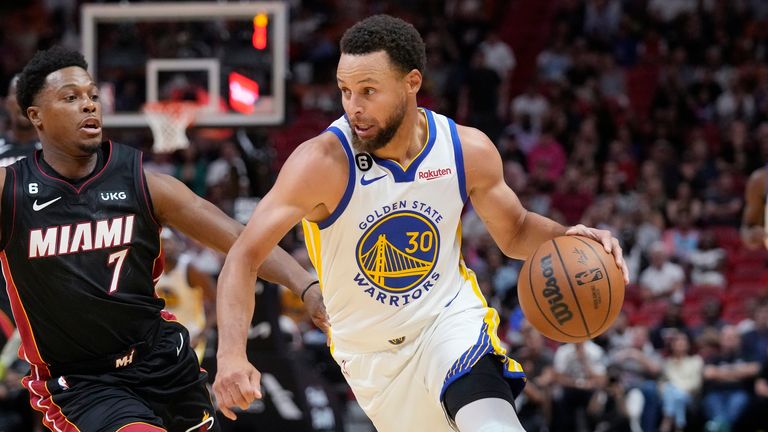 Golden State Warriors guard Stephen Curry (30) drives to the basket past Miami Heat guard Kyle Lowry (7) during the first half of an NBA basketball game, Tuesday, Nov. 1, 2022, in Miami.
