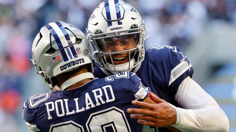 Dallas Cowboys' Dak Prescott congratulates Tony Pollard on his touchdown run during the first half of an NFL football game Sunday, Oct. 30, 2022, in Arlington, Texas. (AP Photo/Ron Jenkins)