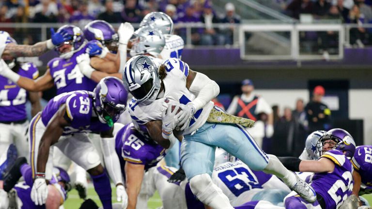 Dallas Cowboys running back Ezekiel Elliott (21) scores on a 1-yard touchdown run during the second half of an NFL football game against the Minnesota Vikings, Sunday, Nov. 20, 2022, in Minneapolis. (AP Photo/Andy Clayton-King)