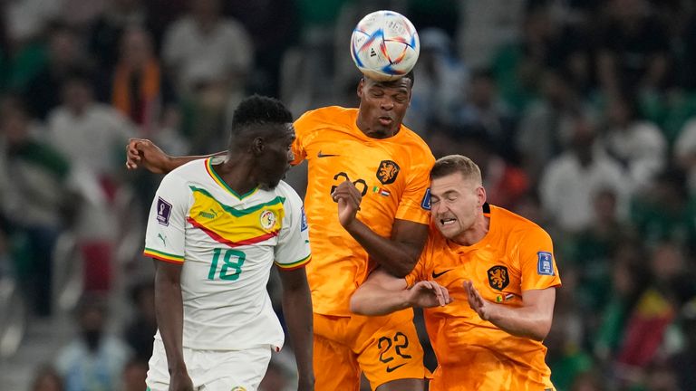 Denzel Dumfries jumps for a header with team-mate Matthijs de Ligt and Senegal's Ismaila Sarr