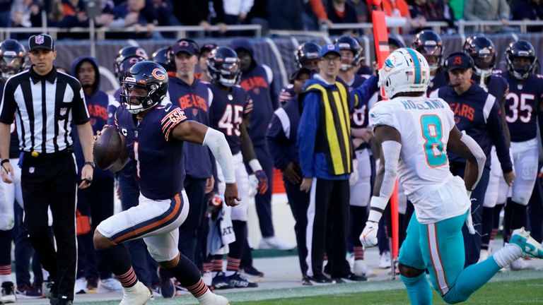 Chicago Bears quarterback Justin Fields (1) runs the ball as Miami Dolphins safety Jevon Holland (8) closes in during the second half of an NFL football game, Sunday, Nov. 6, 2022 in Chicago. (AP Photo/Charles Rex Arbogast)


