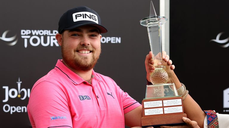 JOHANNESBURG, SOUTH AFRICA - NOVEMBER 27: Dan Bradbury of England is presented with the winners trophy after the final round of the Joburg Open at Houghton GC on November 27, 2022 in Johannesburg, South Africa. (Photo by Luke Walker/Getty Images)

