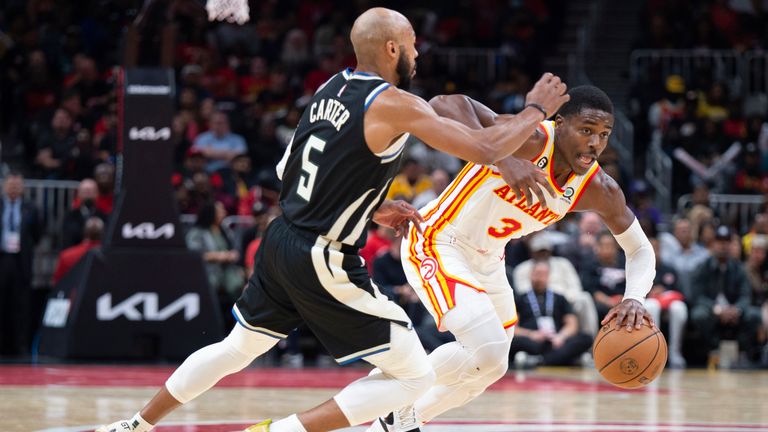 Atlanta Hawks&#39; Aaron Holiday, right, drives to the basket past Milwaukee Bucks&#39; Jevon Carter during the second half of an NBA basketball game Monday, Nov. 7, 2022, in Atlanta