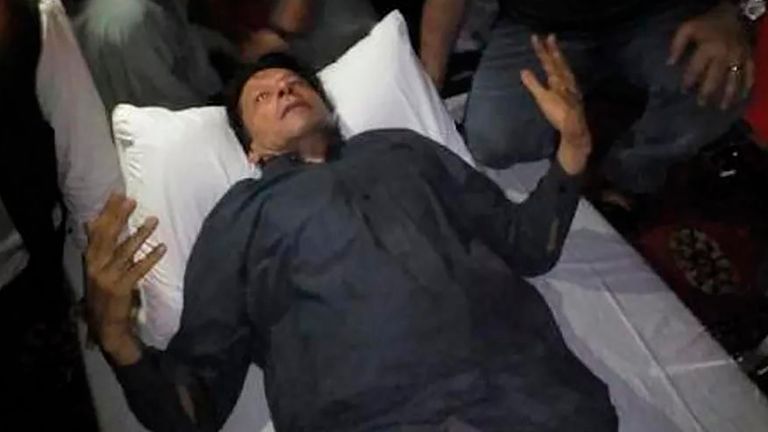 In this photo released by former Pakistani Prime Minister Imran Khan's party, Pakistan Tehreek-e-Insaf, Imran Khan, who injured in a shooting incident, is seen after the incident, in in Wazirabad, Pakistan, Thursday, Nov. 3, 2022. A gunman opened fire at a campaign truck carrying Khan on Thursday, wounding him slightly and also some of his supporters, a senior leader from his party and police said. (Pakistan Tehreek-e-Insaf via AP)