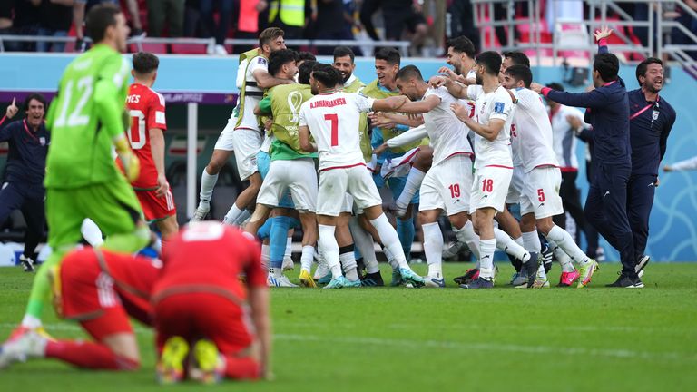 Iran&#39;s players celebrate Roozbeh Cheshmi&#39;s goal late in the game