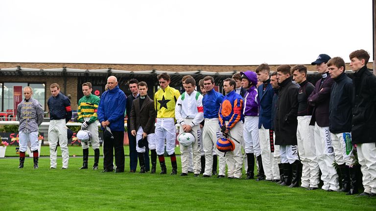 Jockeys and officals lead a minute's silence in honour of Jack de Bromhead at the Curragh