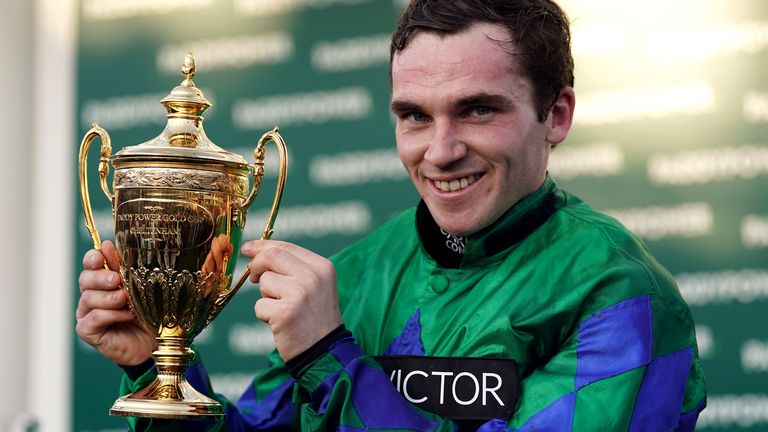 Johnny Burke lifts the Paddy Power Gold Cup after winning on Ga Law at Cheltenham