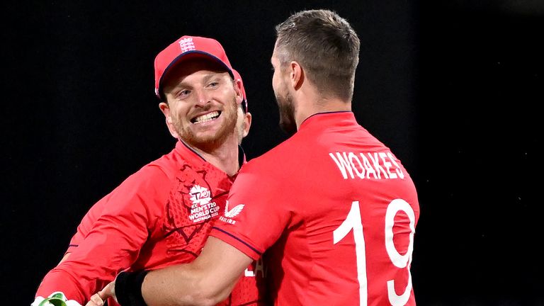 Chris Woakes and Jos Buttler celebrate the dismissal of Devon Conway