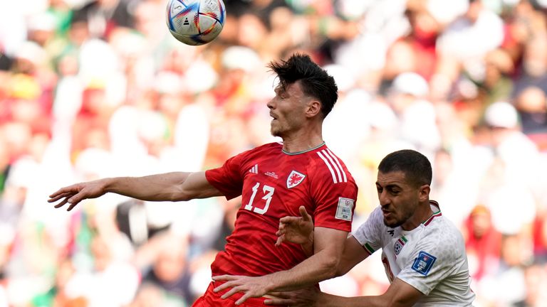 Kieffer Moore and Majid Hosseini compete for a header during the World Cup, group B match between Wales and Iran