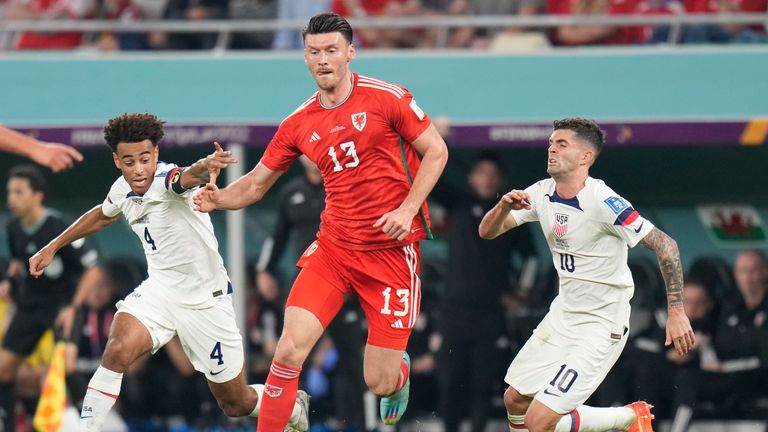 Wales&#39; Kieffer Moore in action between Tyler Adams, left, and Christian Pulisic of the United States 