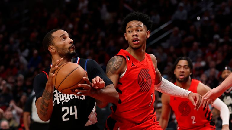 Los Angeles Clippers forward Norman Powell, left, looks to shoot as Portland Trail Blazers guard Anfernee Simons defends during the second half of an NBA basketball game in Portland, Ore., Tuesday, Nov. 29, 2022. (AP Photo/Steve Dipaola)