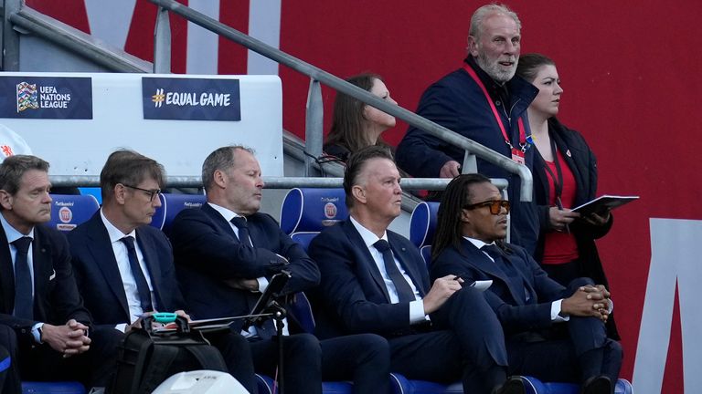 Netherlands coach Louis van Gaal, second from right on the bench, looks out with former Dutch player Edgar Davids, first right, during the UEFA Nations League soccer match between Wales and the Netherlands at Cardiff City Stadium, in Cardiff, Wales, Wednesday, June 8, 2022. (AP Photo/Matt Dunham )