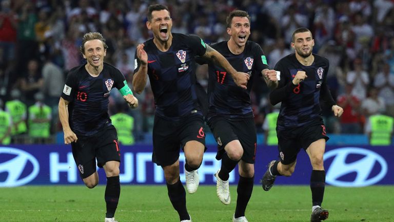 07 July 2018, Russia, Sotchi: Soccer: FIFA'World Cup, Quarter Final: Russia vs Croatia Sotchi stadium. Croatia's players Luka Modric (L-R), Dejan Lovren, Mario Mandzukic and Mateo Kovacic cheer over their win. 