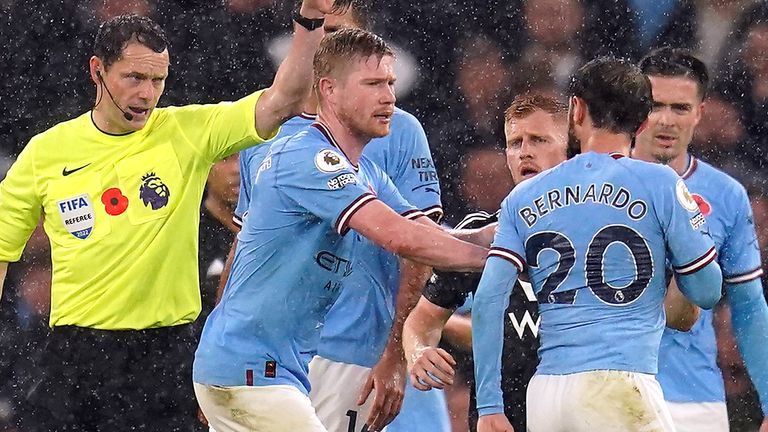 Man City players surround England referee Darren