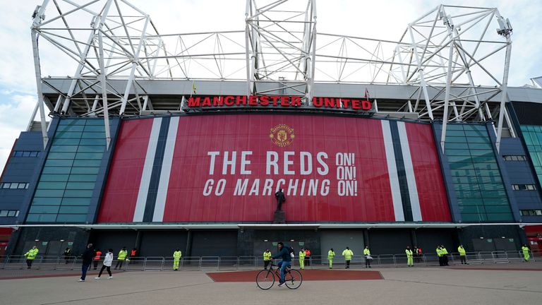 Security and stewards stand outside the Old Trafford stadium in Manchester, England, Tuesday, May 11, 2021 ahead of the English Premier League soccer match between Manchester United and Leicester City. Manchester United&#39;s American owners confirmed Tuesday, Nov. 22, 2022,  they would consider putting the iconic Premier League club up for sale. United said the Glazer family was open to a potential buyout. (AP Photo/Jon Super, FIle)