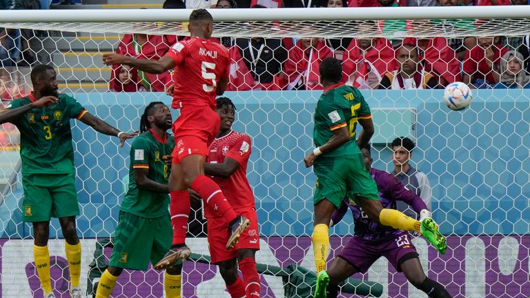 Switzerland's Manuel Akanji outjumps Cameroon defenders to head the ball during the World Cup Group G match
