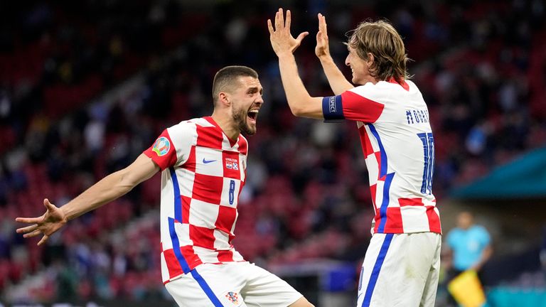 Croatia's Mateo Kovacic, left, and Croatia's Luka Modric celebrate after Croatia's Ivan Perisic scored their 3rd goal during the Euro 2020 soccer championship group D match between Croatia and Scotland at the Hampden Park Stadium in Glasgow, Tuesday, June 22, 2021.