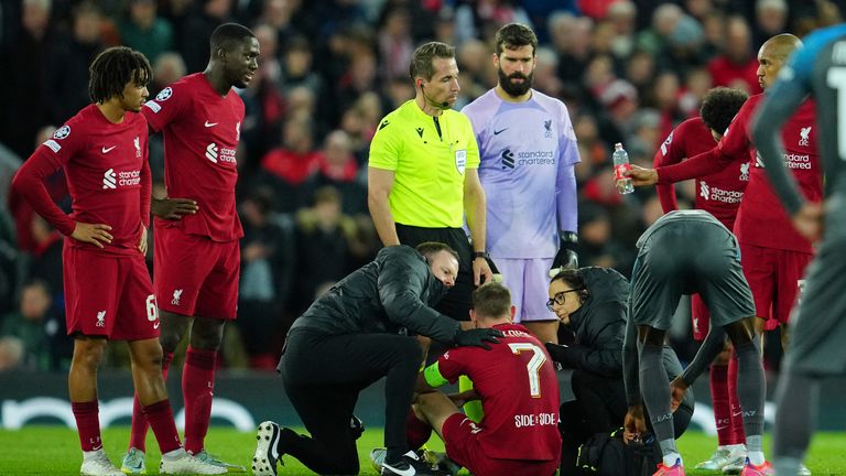 Liverpool's James Milner receives medical treatment after suffering a head injury