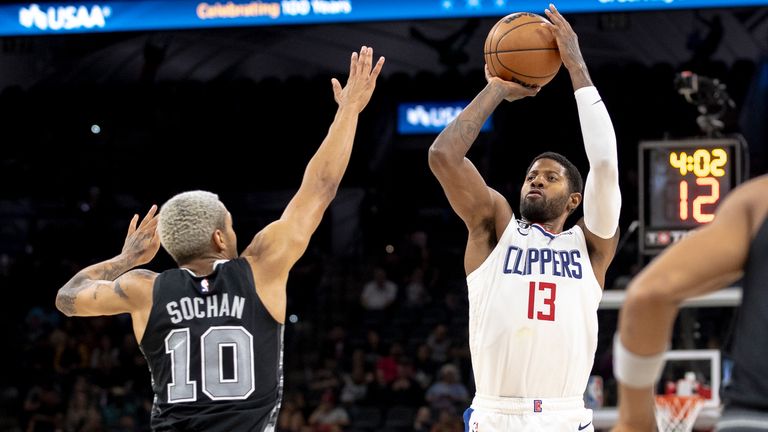 Los Angeles Clippers guard Paul George (13) shoots over San Antonio Spurs forward Jeremy Sochan (10) during the second half of an NBA basketball game, Friday, Nov. 4, 2022, in San Antonio. (AP Photo/Nick Wagner)



