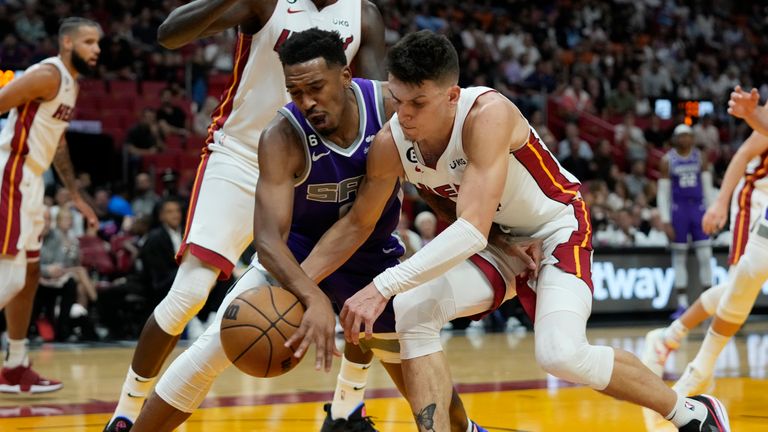 Sacramento Kings guard Malik Monk, left, and Miami Heat guard Tyler Herro battle for a loose ball during the first half of an NBA basketball game, Wednesday, Nov. 2, 2022, in Miami. (AP Photo/Wilfredo Lee)


