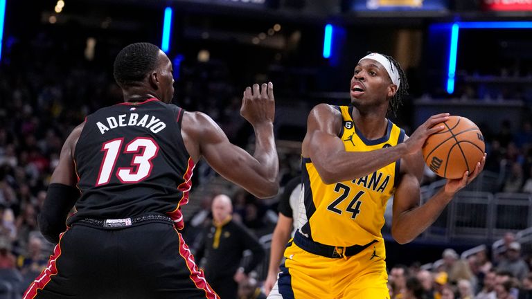Indiana Pacers guard Buddy Hield (24) looks to pass over Miami Heat center Bam Adebayo (13) during the second half of an NBA basketball game in Indianapolis, Friday, Nov. 4, 2022. The Pacers defeated the Heat 101-99. (AP Photo/Michael Conroy)



