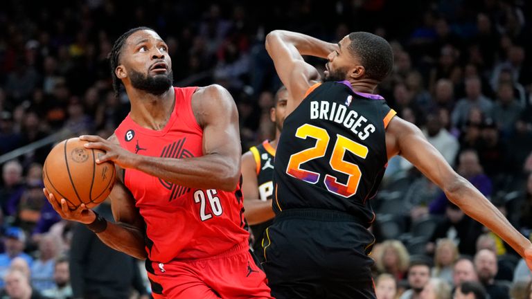 Portland Trail Blazers forward Justise Winslow (26) drives on Phoenix Suns forward Mikal Bridges (25) during the first half of an NBA basketball game, Friday, Nov. 4, 2022, in Phoenix. (AP Photo/Matt York)


