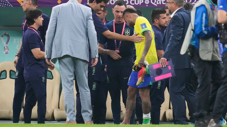 Neymar looks at his injured ankle after coming off the pitch