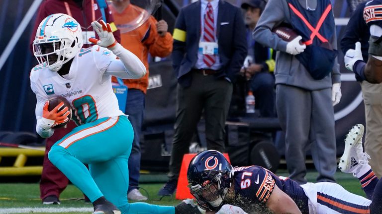 Miami Dolphins wide receiver Tyreek Hill (10) is taken down by Chicago Bears linebacker Jack Sanborn (57) during the second half of an NFL football game, Sunday, Nov. 6, 2022 in Chicago. (AP Photo/Charles Rex Arbogast)


