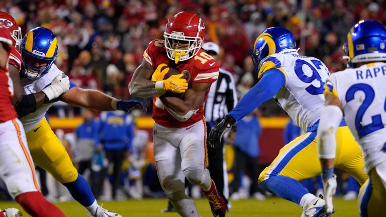 Kansas City Chiefs running back Isiah Pacheco (10) runs from Los Angeles Rams defensive tackle Michael Hoecht, right, during the second half of an NFL football game Sunday, Nov. 27, 2022, in Kansas City, Mo. (AP Photo/Ed Zurga)


