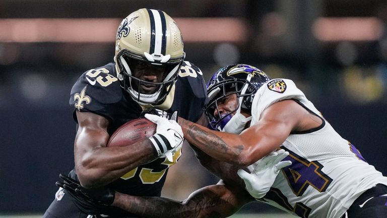 New Orleans Saints tight end Juwan Johnson breaks a tackle by Baltimore Ravens cornerback Marcus Peters and runs for a touchdown in the second half of an NFL football game in New Orleans, Monday, Nov. 7, 2022.