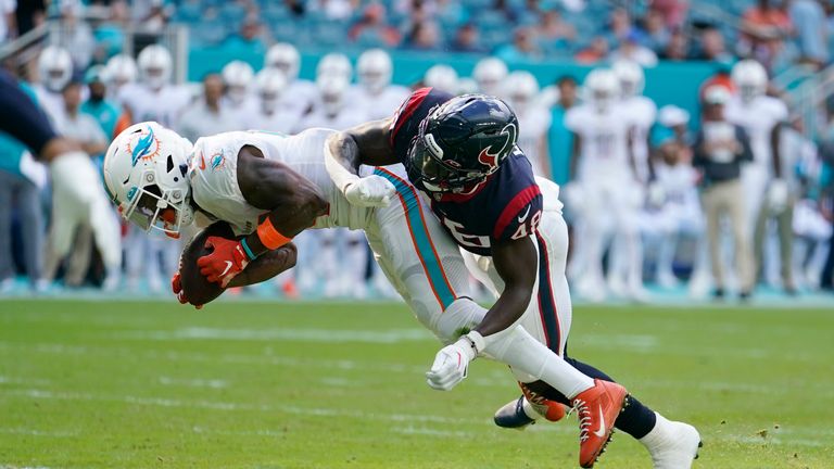Miami Dolphins wide receiver Trent Sherfield (14) is tackled by Houston Texans linebacker Christian Harris (48) during the first half of an NFL football game, Sunday, Nov. 27, 2022, in Miami Gardens, Fla. (AP Photo/Lynne Sladky)


