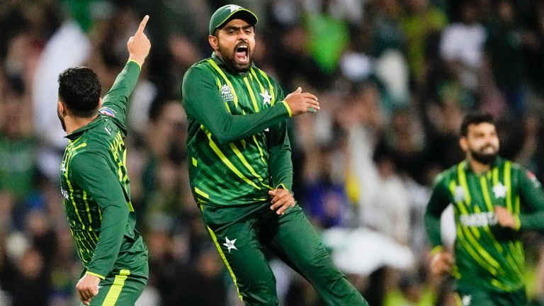 Pakistan's Mohammad Nawaz, left, is congratulated by a teammate after dismiss New Zealand's Glenn Phillips during the T20 World Cup cricket semifinal between New Zealand and Pakistan in Sydney, Australia, Wednesday, Nov. 9, 2022. (AP Photo/Rick Rycroft)