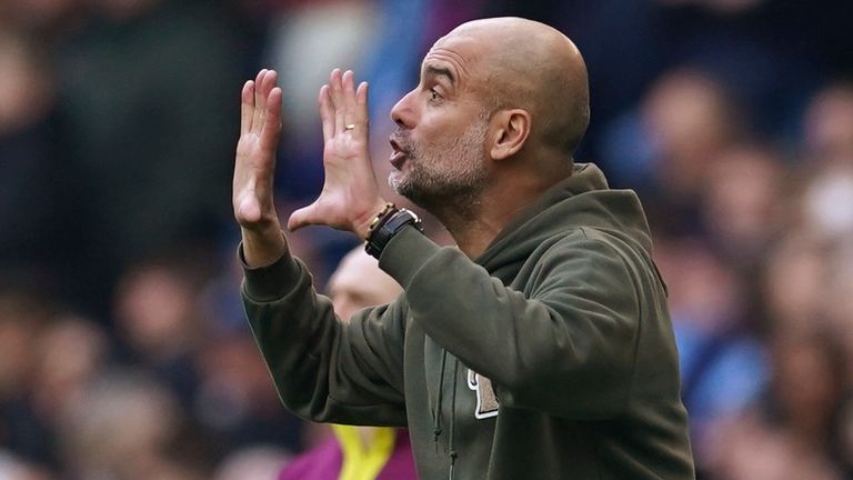 Pep Guardiola gestures to his players with 10 minutes of injury time to play
