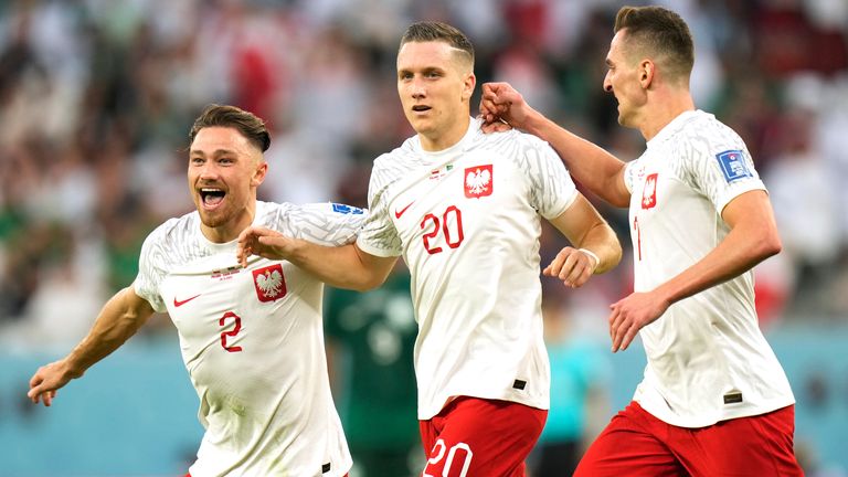 Poland&#39;s Piotr Zielinski celebrates with team-mates after scoring