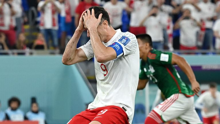 Robert Lewandowski holds his head in his hands after seeing his penalty saved