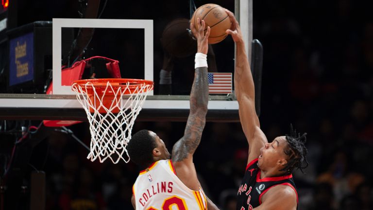 Toronto Raptors forward Scottie Barnes scores over Atlanta Hawks forward John Collins