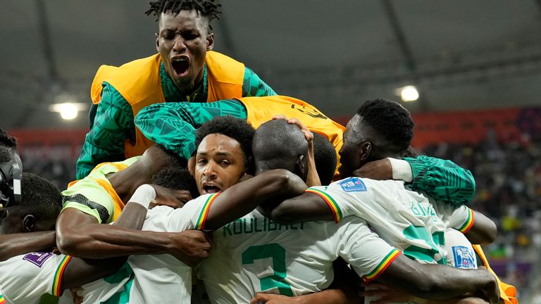 Senegal players celebrate after retaking the lead against Ecuador