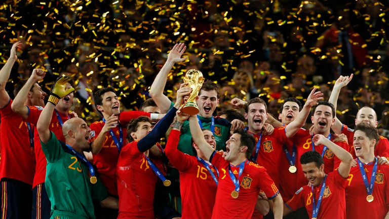 Spain's David Villa, Sergio Ramos and Fernando Llorente hold up the World Cup trophy as they celebrate their win over the Netherlands in 2010