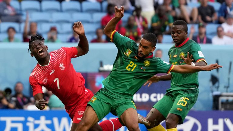 Switzerland's Breel Embolo (left) is challenged by Cameroon's Jean-Charles Castelletto (centre) and Tolo Nouhou during the World Cup Group G match